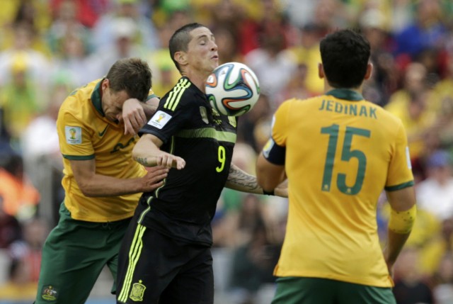 Spain's Fernando Torres fights for the ball with Australia's Ivan Franjic and Mile Jedinak during their 2014 World Cup Group B soccer match at the Baixada arena