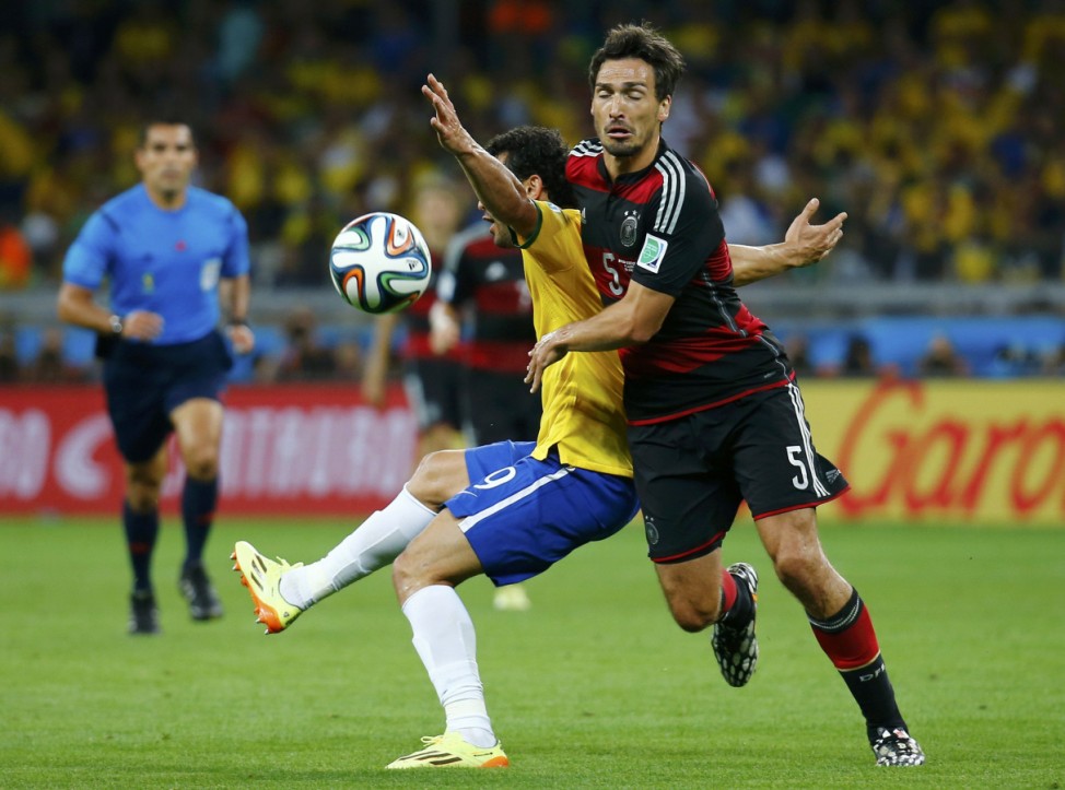 Brazil's Fred fights for the ball with Germany's Hummels during their 2014 World Cup semi-finals at the Mineirao stadium in Belo Horizonte