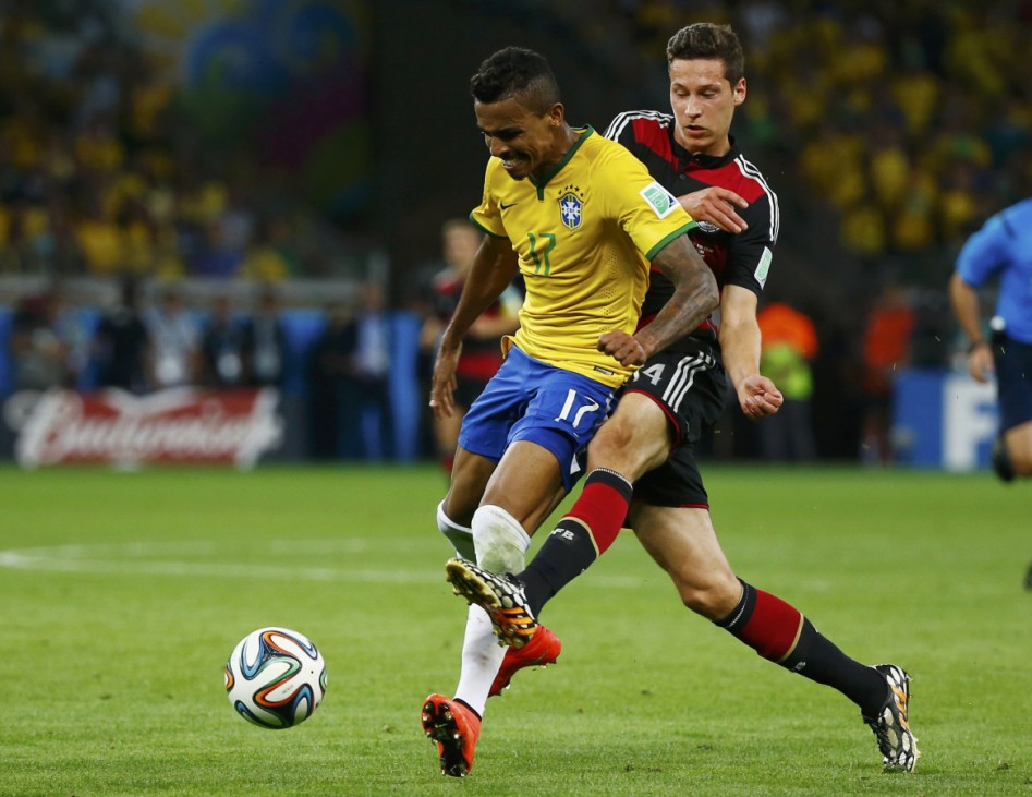 Brazil's Gustavo fights for the ball with Germany's Draxler during their 2014 World Cup semi-finals at the Mineirao stadium in Belo Horizonte