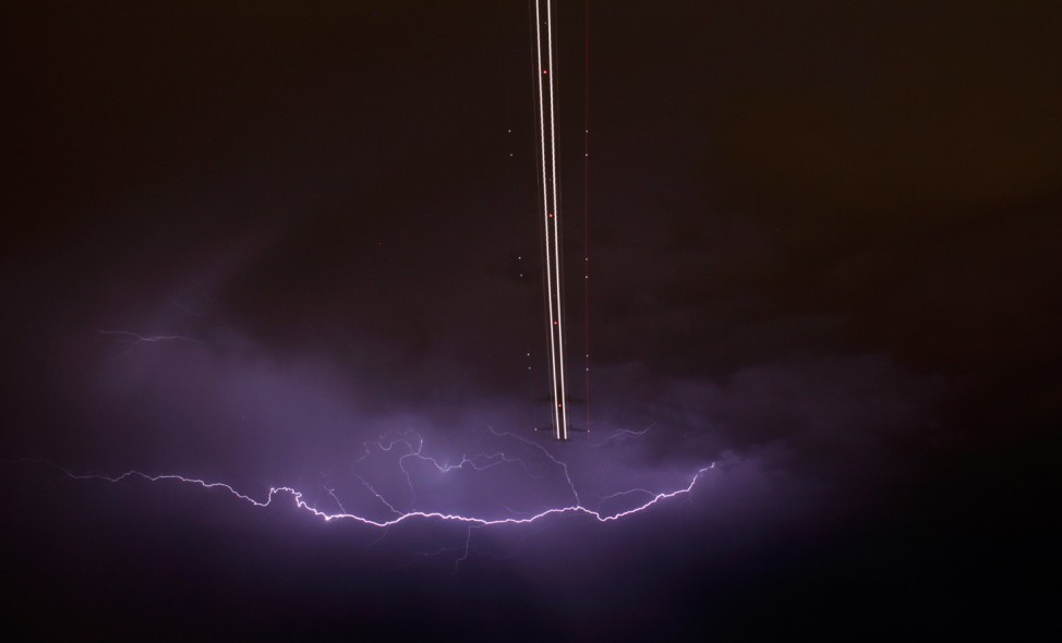 Jet aircraft takes off as lightning strikes across the sky during a monsoon storm at McCarran International Airport in Las Vegas, Nevada