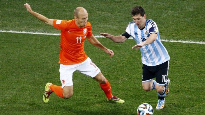 Arjen Robben of the Netherlands fights for the ball with Argentina's Lionel Messi during their 2014 World Cup semi-finals at the Corinthians arena