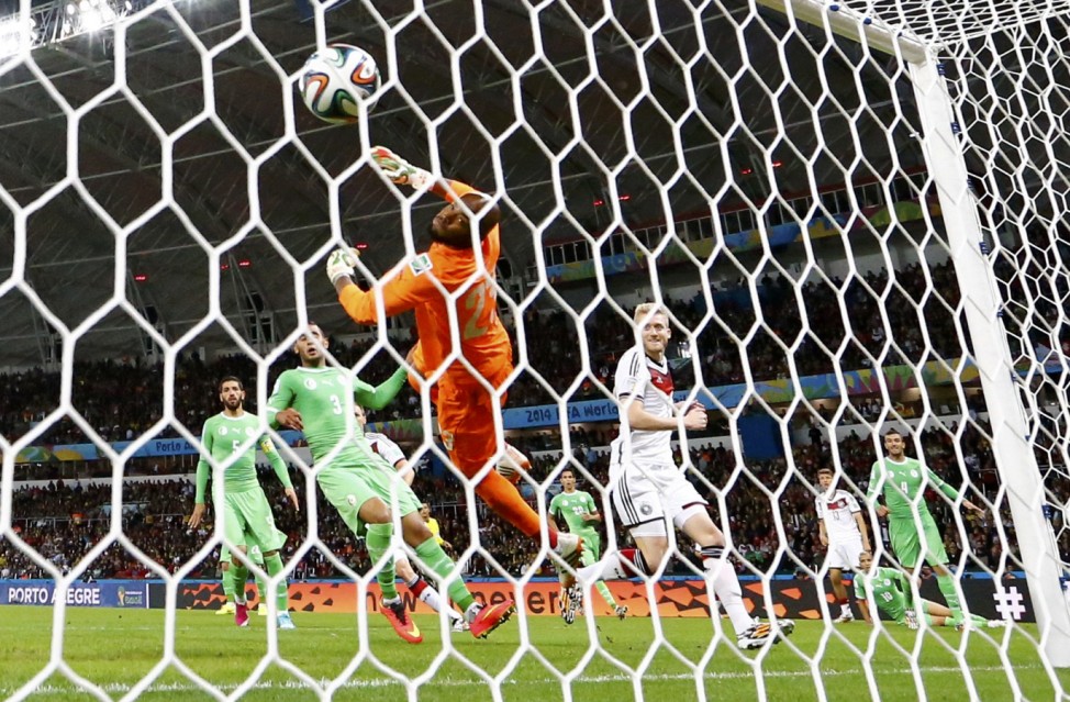 Germany's Andre Schuerrle scores past Algeria's goalkeeper Rais Mbolhi during their 2014 World Cup round of 16 game at the Beira Rio stadium