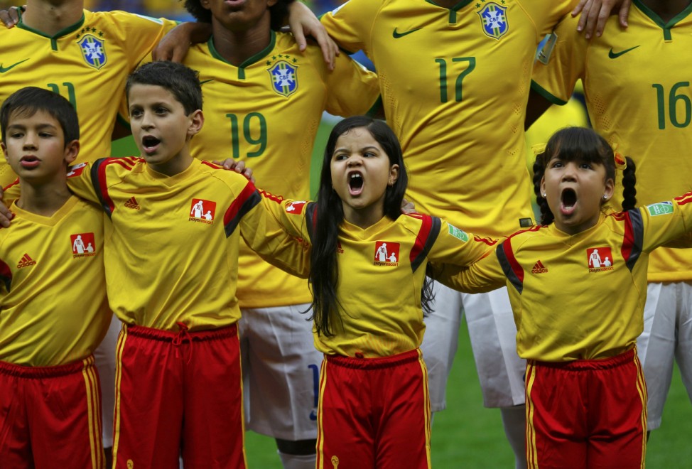 Children along with Brazil's Oscar, Willian, Luiz Gustavo and Ramires sing the national anthem before their 2014 World Cup third-place playoff against the Netherlands at the Brasilia national stadium in Brasilia