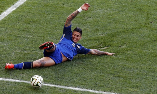 Argentina's Marcos Rojo slides for the ball during their 2014 World Cup final against Germany at the Maracana stadium in Rio de Janeiro