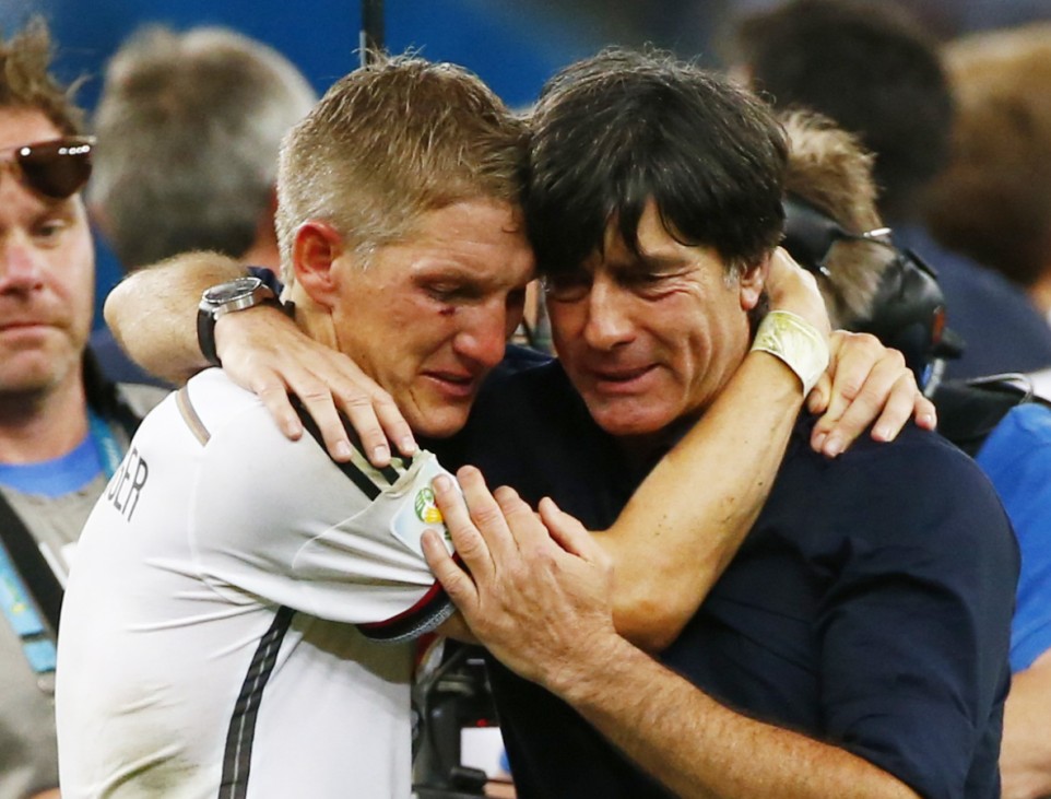 Germany's Schweinsteiger embraces coach Joachim Loew as they celebrate their win against Argentina after their 2014 World Cup final at the Maracana stadium in Rio de Janeiro