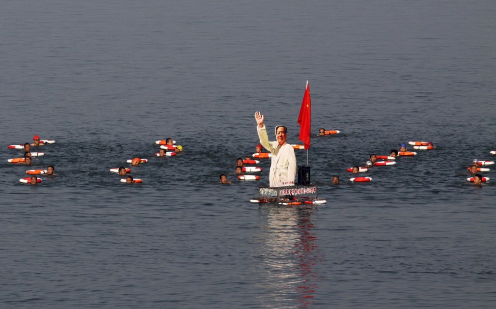 Participants swim together with a portrait of late Chinese Chairman Mao in the Hanjiang River in Xiangyang
