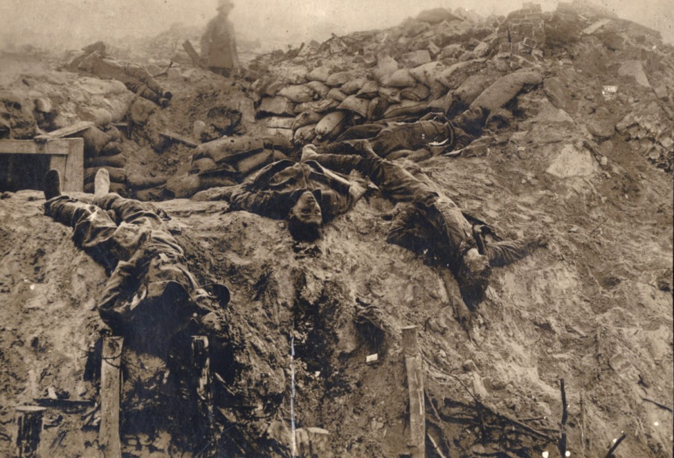 Dead British soldiers are pictured at a machine gun position on the Western Front in this 1918 handout picture