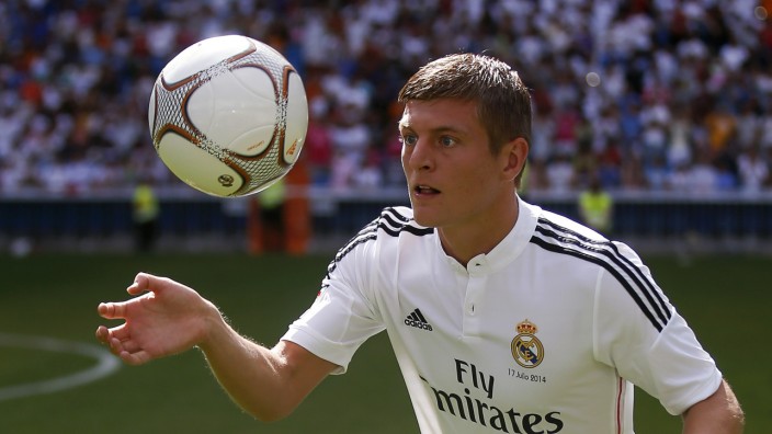 New Real Madrid midfielder Kroos of Germany controls the ball during his presentation at Santiago Bernabeu stadium in Madrid