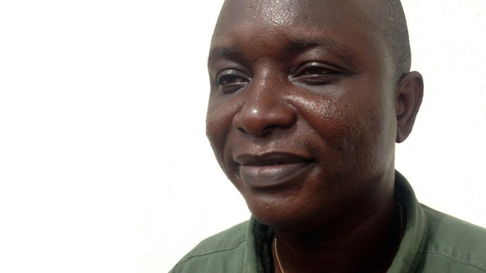 Khan, head doctor fighting the deadly tropical virus Ebola in Sierra Leone, poses in Freetown