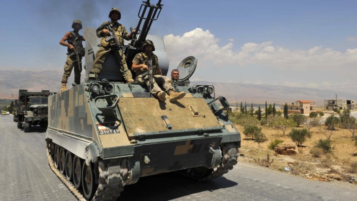 Lebanese army soldiers on armoured carriers and military vehilces advance towards Sunni Muslim border town of Arsal, in eastern Bekaa Valley as part of reinforcements