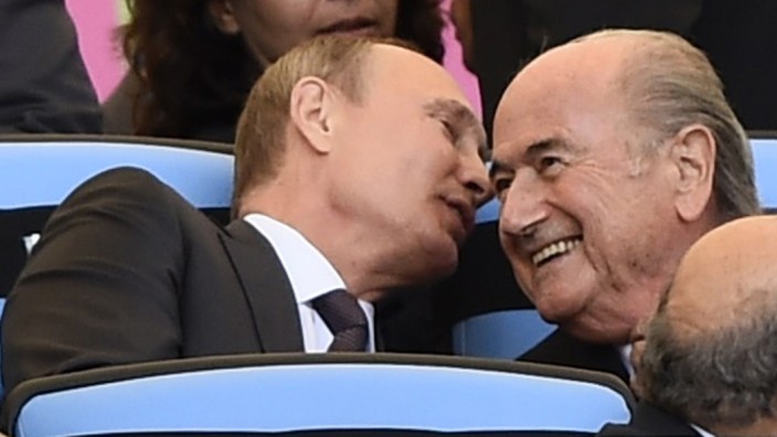 Russian President Putin speaks to FIFA President Blatter during the 2014 World Cup final between Germany and Argentina in Rio de Janeiro