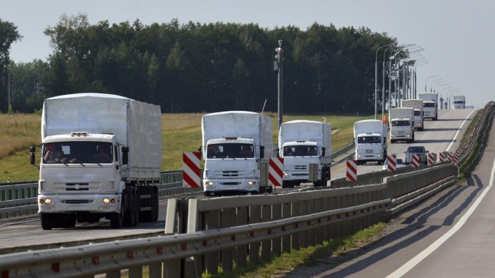 A Russian convoy of trucks carrying humanitarian aid for Ukraine drives along a road near the city of Yelets
