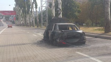 Kämpfe in Ostukraine: Alltag in Donezk: Ausgebranntes Auto am Lenin-Prospekt, Sonntagvormittag.