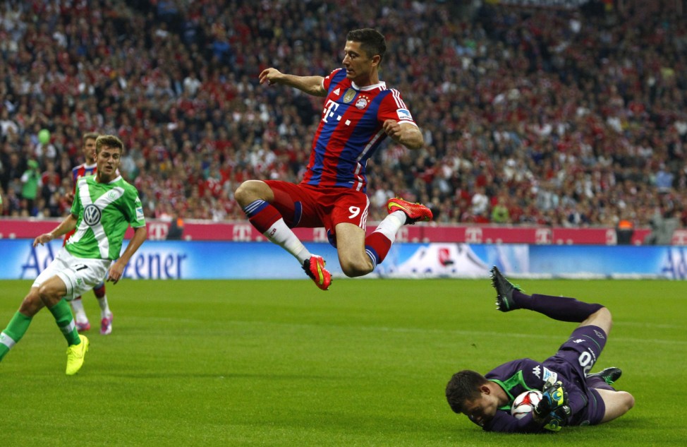 Bayern Munich's Lewandowski jumps over Wolfsburg's Gruen during German Bundesliga first division soccer match in Munich