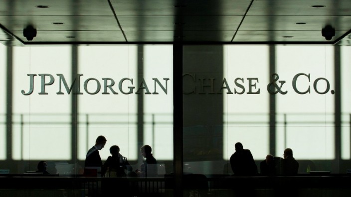 People walk inside JP Morgan headquarters in New York