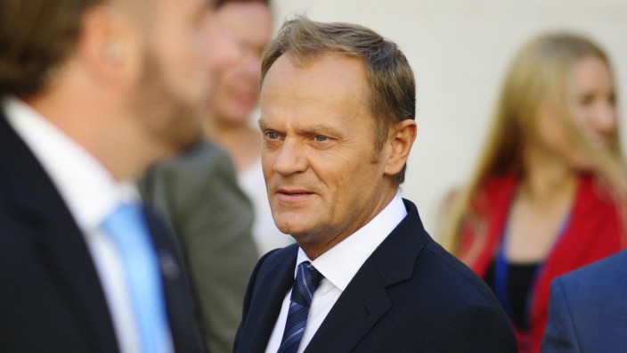 Poland's PM Tusk walks outside the parliament in Warsaw