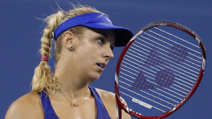 Lisicki of Germany reacts after losing a point against Sharapova of Russia during their women's singles match at the U.S. Open tennis tournament in New York