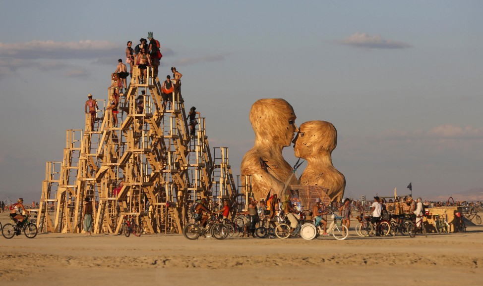 People interact with art installations during the Burning Man 2014 'Caravansary' arts and music festival in the Black Rock Desert of Nevada