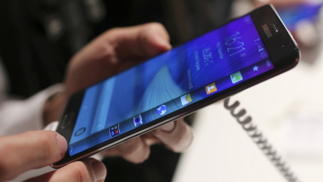 A visitor holds a new Samsung Galaxy Note Edge smartphone after its presentation at the Unpacked 2014 Episode 2 event ahead of the IFA Electronics show in Berlin