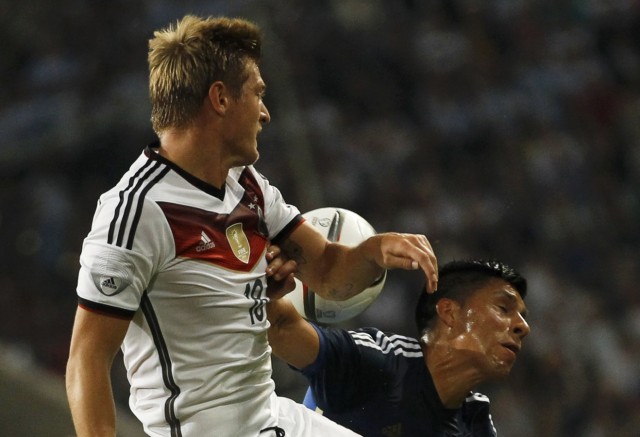 Germany's Kroos fights for the ball with Argentina's Perez during their friendly soccer match in Duesseldorf