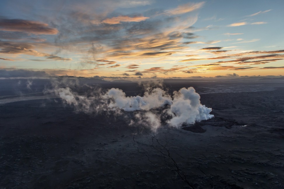 Steam and smoke rise over a 1-km-long fissure in a lava field north of the Vatnajokull glacier, which covers part of Bardarbunga volcano system