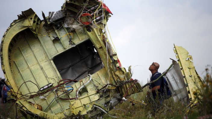 File photo of a Malaysian air crash investigator inspecting the crash site of Malaysia Airlines Flight MH17, near the village of Hrabove