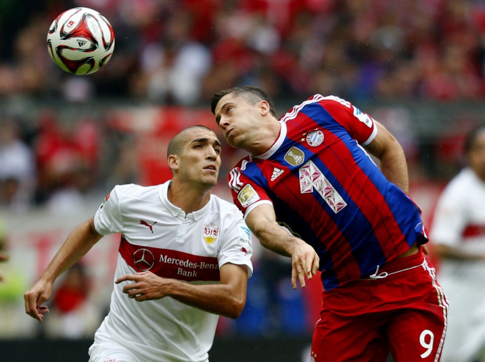 Munich's Lewandowski challenges Stuttgart's Vidal during their German first division Bundesliga soccer match in Munich