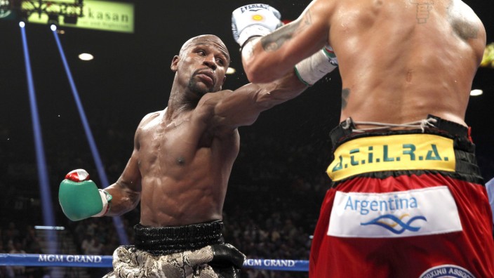 Mayweather Jr. jabs at Maidana during their title fight at the MGM Grand Garden Arena in Las Vegas