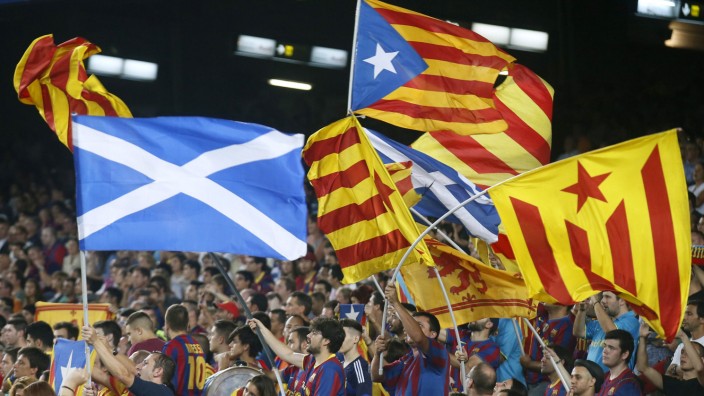Catalunya's separatist supporters wave 'Esteladas' supporting Scotland's independence during FC Barcelona's Champions League soccer match against Apoel Nicosia in Barcelona