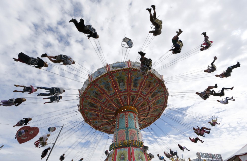 Visitors ride a merry-go-round during the opening day of  the 181st Oktoberfest in Munich