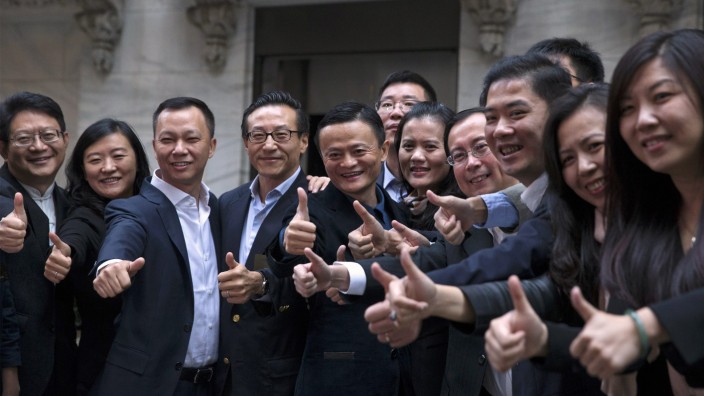 Alibaba founder Jack Ma and co-founder and VP Joseph Tsai pose with employees as they arrive for the company's IPO at the NYSE in New York