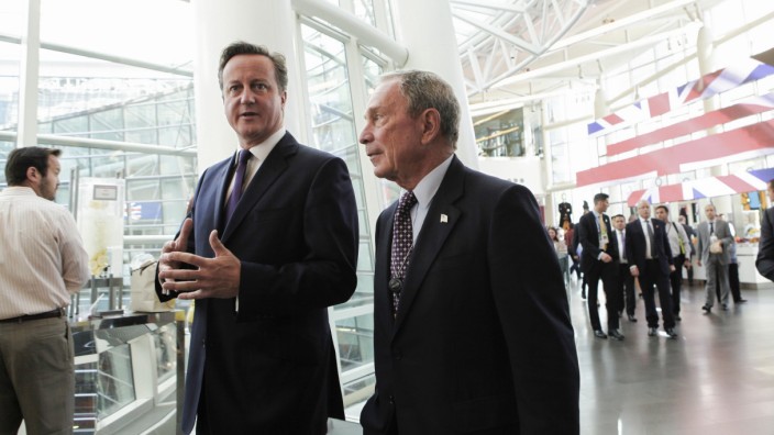 British Prime Minister David Cameron speaks with Michael Bloomberg at the company's headquarters in New York