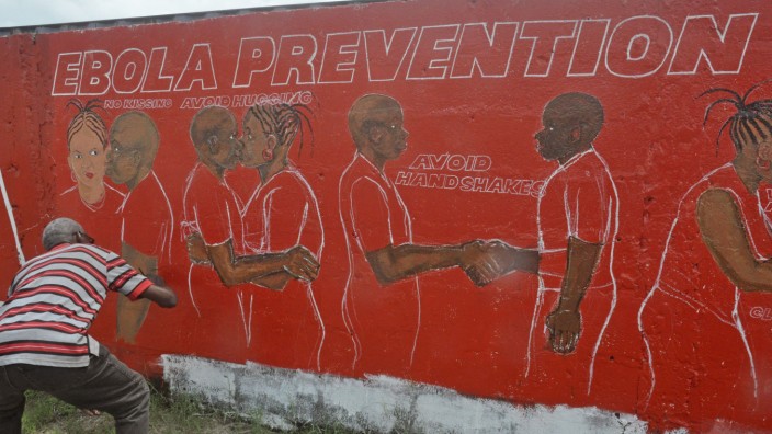 Ebola: Aufklärung über alle Kanäle: In Liberia wird eine Mauer mit Botschaften bemalt, wie eine Ansteckung mit dem Ebola-Virus vermieden werden kann.