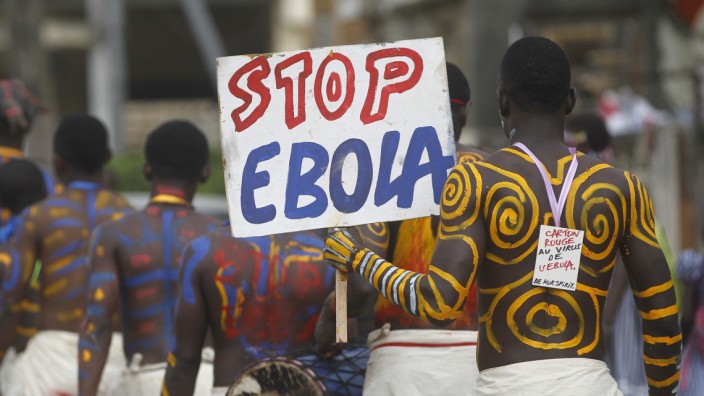 Actors parade on a street after performing at Anono school, during an awareness campaign against Ebola in Abidjan