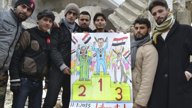 Demonstrators hold a placard during a protest against Syria's President Bashar al-Assad, after Friday prayers in Kafranbel