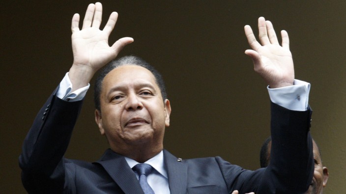 File picture of former Haitian dictator Jean-Claude 'Baby Doc' Duvalier greeting the crowd from his hotel in Port-au-Prince