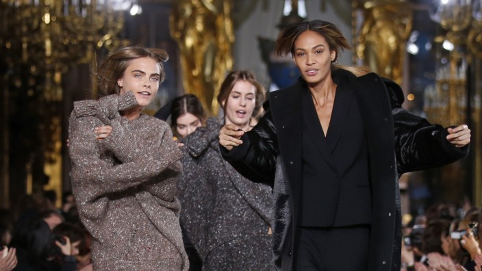 Models Cara Delevingne and Joan Smalls present creations by British designer Stella McCartney as part of her Fall/Winter 2014-2015 women's ready-to-wear collection show during Paris Fashion Week