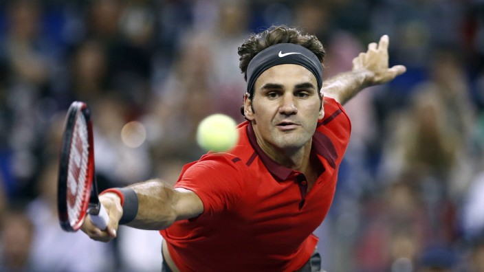 Roger Federer of Switzerland returns a shot to Gilles Simon of France during the men's singles final match at the Shanghai Masters tennis tournament in Shanghai
