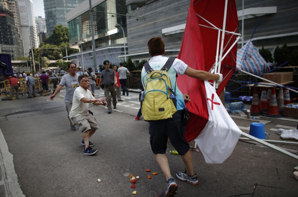 An Anti-Occupy Central protester drags away a tent at the main protest site in Admiralty in Hong Kong