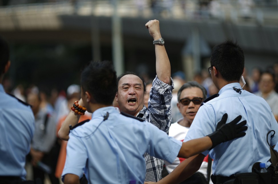 An anti-Occupy Central protester gestures and shouts at pro-democracy protesters at the main protest site in Admiralty in Hong Kong