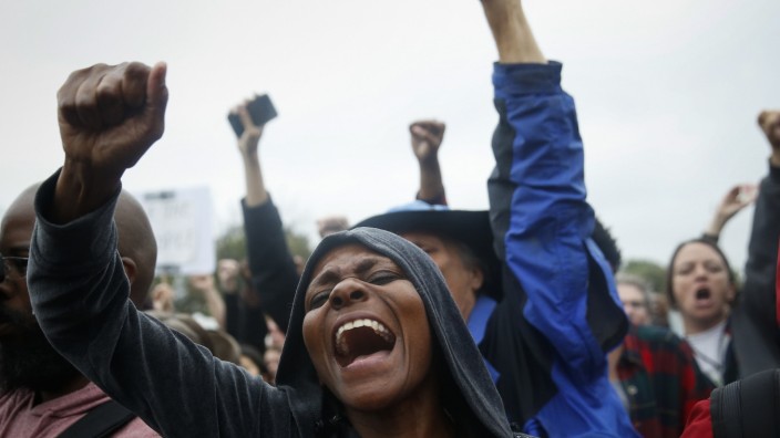 Protesters rally during a demonstration outside the Ferguson police department in Ferguson, Missouri