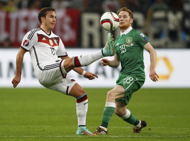 Germany's Goetze kicks the ball next to Ireland's Quinn during their Euro 2016 Group D qualification soccer match in Gelsenkirchen