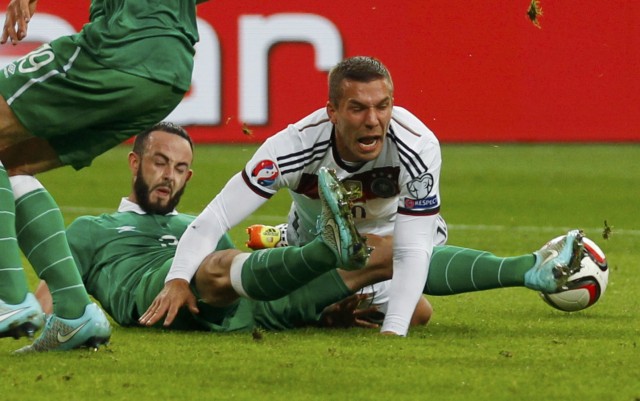 Ireland's Wilson attacks Germany's Podolski during their Euro 2016 Group D qualification soccer match in Gelsenkirchen