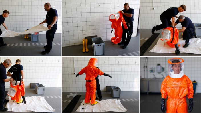 A combination of pictures shows fire brigade paramedic being assisted while putting on a sealed protective suit during a drill in Frankfurt