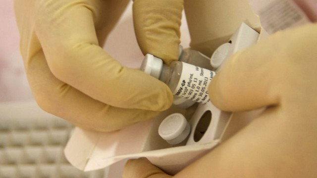 Scientists at the National Microbiology Lab in Winnipeg prepare an experimental Ebola vaccine for shipment to the World Health Organization