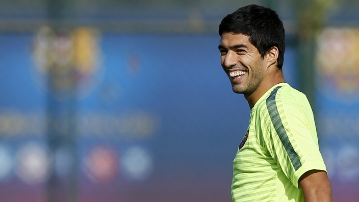 Barcelona's players Luis Suarez smiles during a training session at Joan Gamper training camp