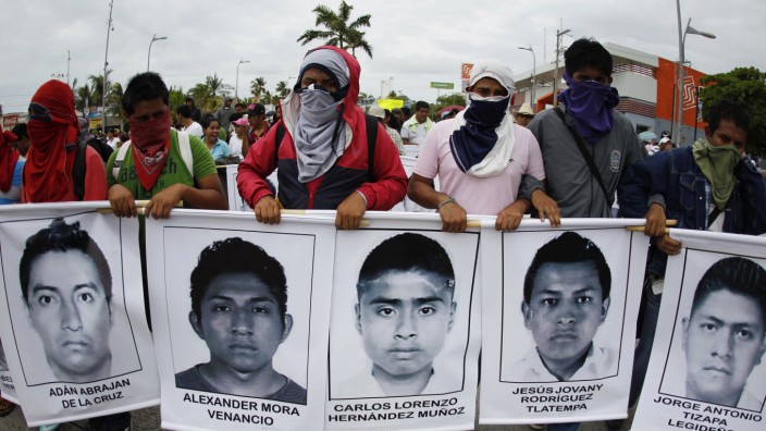Students from the Ayotzinapa Teacher Training College carry photographs of missing students during a march in Acapulco