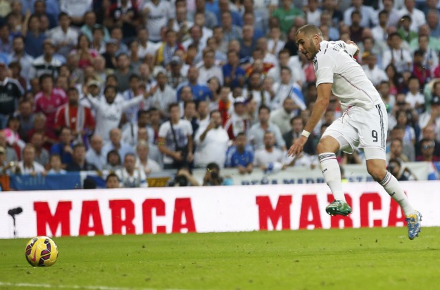Real Madrid's Benzema shoots to score against Barcelona during their Spanish first division 'Clasico' soccer match at the Santiago Bernabeu stadium in Madrid