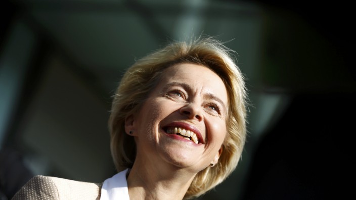 German Defence Minister Von der Leyen smiles after evacuation following fire alarm during news conference in Berlin