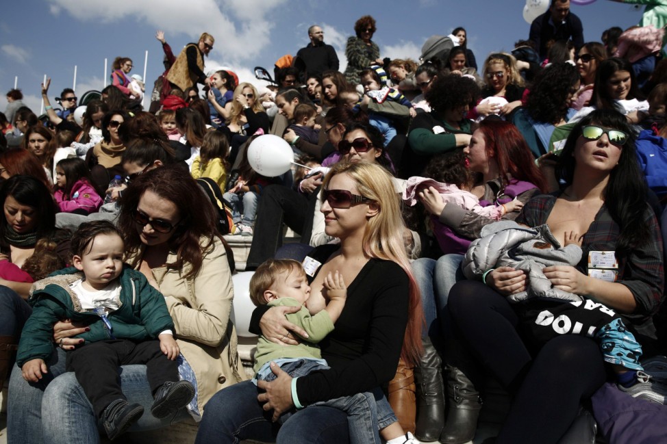 Women breastfeed babies during a mass event in Athens